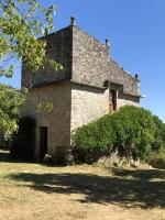 an old stone building with a tree in front of it at Maison d&#39;une chambre avec jardin clos a Tour de Faure in Tour-de-Faure