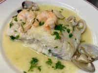 une assiette blanche garnie de crevettes et de champignons dans l'établissement Hotel Lasa Sport, à Valladolid