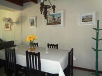 a dining room table with a white tablecloth and flowers on it at Casa com Piscina Paraty in Paraty