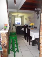 a kitchen and living room with a table and chairs at Casa com Piscina Paraty in Paraty