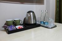 a tray with a coffee maker and bottles on a counter at Stop Hotel in Braşov