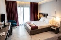 A bed or beds in a room at Lagaria Hotel