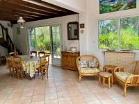 a dining room with a table and chairs at Cottage with a big idyllic garden at the lake in Lacanau