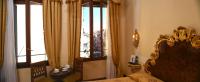 a bedroom with a bed and a large window at Hotel San Moisè in Venice