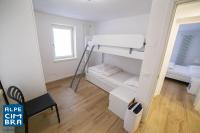 Łóżko lub łóżka w pokoju w obiekcie Trentino Apartments - Casa ai Tolleri