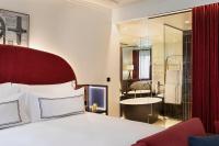 a hotel room with a bed and a bathroom at Villa Marquis Member of Meliá Collection in Paris