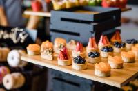 a bunch of small pastries on a wooden tray at InterContinental Sydney Double Bay by IHG in Sydney