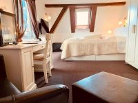 a bedroom with a bed and a desk with a computer at Pension Karina Schwerin in Schwerin