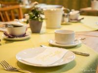a table with plates and cups and a napkin at Pension Ehrenfried - Hotel garni in Kindberg