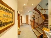 a hallway with stairs and a painting on the wall at Pension Ehrenfried - Hotel garni in Kindberg