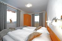 A bed or beds in a room at Glemmy Appartements inkl Sommercard