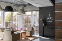 a lobby with couches and tables and large windows at Ramada Encore Kyiv in Kyiv