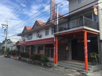 a building with orange poles on the side of a street at Golden flower Homestay in Yuli