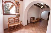 a living room with two chairs and an arched window at Hostal El Cortijo in Algodonales