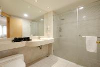 a bathroom with a sink and a glass shower at Hotel Sunshine in Kaohsiung