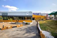 a k hybrid store with a park in front of it at Kyriad La Roche Sur Yon in La Roche-sur-Yon