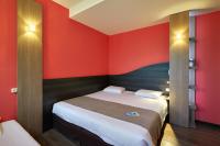 a bedroom with red walls and a large bed at Kyriad La Roche Sur Yon in La Roche-sur-Yon