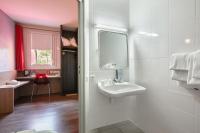 a bathroom with a sink and a mirror at Kyriad La Roche Sur Yon in La Roche-sur-Yon