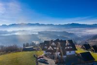 an aerial view of a house on a hill with a fog at Willa Sulejowka in Poronin
