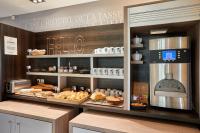 a bakery with a display case with pastries and bread at Kyriad La Roche Sur Yon in La Roche-sur-Yon