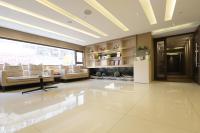 a large room with a lobby with white furniture at Talmud Hotel Yizhong in Taichung