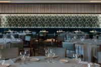 a dining room with tables and chairs with wine glasses at Hotel La Palma in Stresa