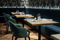 a restaurant with two tables and chairs with glasses on them at Hotel La Palma in Stresa