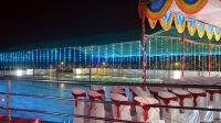 a pool on a cruise ship at night at Mango Valley Resort Ganpatipule in Ratnagiri