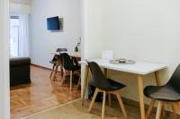 A television and/or entertainment centre at Newly Renovated Athenian Apt with Balcony