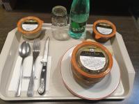 a tray with a plate of food on a table at The Originals City, Hôtel L&#39;Acropole, Saint-Etienne Sud (Inter-Hotel) in La Ricamarie