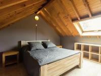 a bedroom with a bed in a room with a window at Perfect spot on the edge of a large wood in Awenne