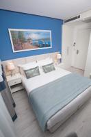 a bedroom with a large bed with blue walls at Ravvda Hotel in Istanbul