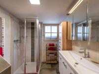 a bathroom with a shower and a sink at s´Brunnhäusl in Kelchsau