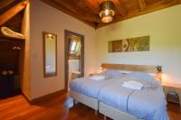 a bedroom with a bed with blue sheets and a ceiling at Domaine d&#39;Essendiéras in Saint-Médard-dʼExcideuil
