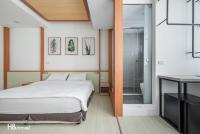 a bedroom with a bed and a walk in shower at Taitung Spring Homestay B&amp;B in Taitung City