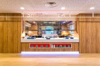 a large kitchen with wooden walls and a counter at Paradise Park Fun Lifestyle Hotel in Los Cristianos