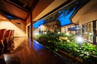 a room with a balcony with chairs and plants at Hotel Io Alpheratz in Kasama