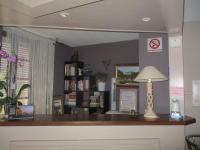 a room with a table with a lamp on it at Hotel Du Commerce in Pont-Saint-Esprit