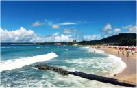 a beach with a group of people in the water at Mong Shan Homestay in Kenting