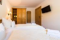 A bed or beds in a room at Landgasthof Bierfriedl