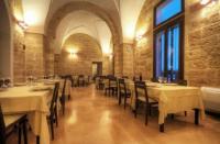 a dining room with tables and chairs in a building at Masseria Li Campi in Cavallino di Lecce