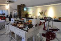 a buffet in a restaurant with food on a table at UNAHOTELS Club Hotel Ancora in Stintino