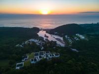 una vista aérea de un río al atardecer en The Estuary Hotel &amp; Spa, en Port Edward