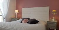 a bedroom with a bed with two lamps and two pillows at La maison Virginie logements de 1 à 5 pers chaleureux centre, parking, linge, wifi, proximité lac canal piscine in Montargis
