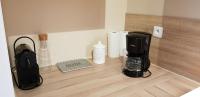 a coffee maker on a counter in a kitchen at La maison Virginie logements de 1 à 5 pers chaleureux centre, parking, linge, wifi, proximité lac canal piscine in Montargis