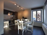 a kitchen and dining room with a table and chairs at Modern Holiday Home in Florenville with Garden in Chassepierre