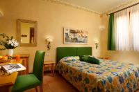 a bedroom with a bed and a table and a chair at Hotel Santa Maria in Rome
