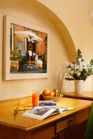 a wooden table with an umbrella and a drink on it at Hotel Santa Maria in Rome