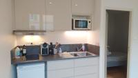 a kitchen with white cabinets and a sink at Appartement rénové centre historique in Bordeaux
