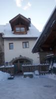 a house with snow on the ground in front of it at Le Bacchu Ber in Briançon